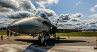 A fighter jet is shown, potentially maintained by L3Harris.