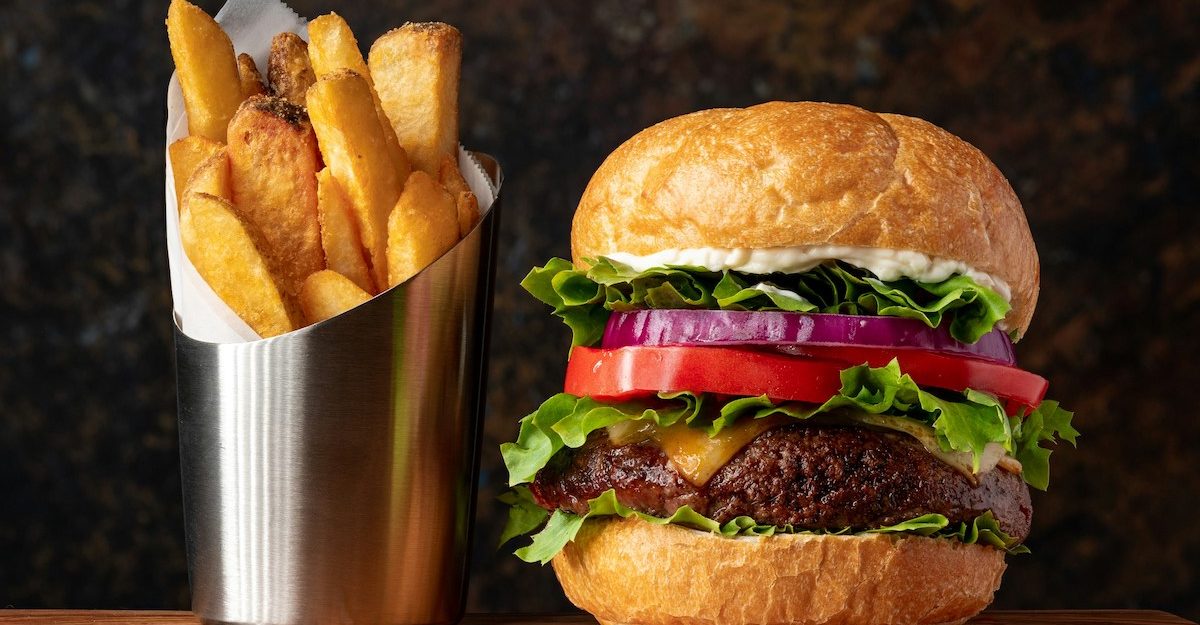 A hamburger and fries, a fast food staple from companies like MBI Brands.