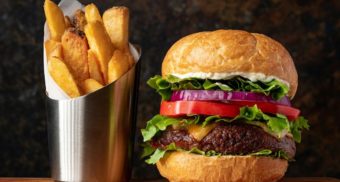 A hamburger and fries, a fast food staple from companies like MTY Food Group.