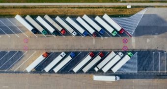 A number of parked transport trucks, potentially carrying products packaged by CHEP Canada.