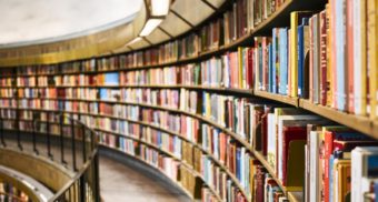 A photo of books on circular bookshelves. (Photo: Susan Q Yin / Unsplash)