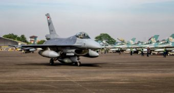 A close up shot of a fighter jet sitting on a runway, potentially built by Lockheed Martin.