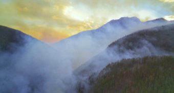 A photo of smoke rising from a wildfire. (Photo: Landon Parenteau / Unsplash)