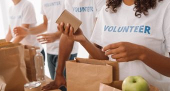 A photo of volunteers bagging food. (Photo: Blessings of Hope / Google Images)