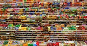 Many rows of shelves, potentially at a Buck or Two Plus location in Canada, are loaded with products.