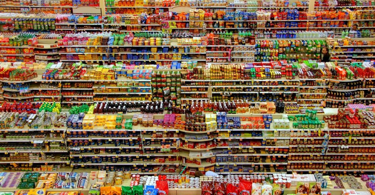 Many rows of shelves, potentially at a Buck or Two Plus location in Canada, are loaded with products.