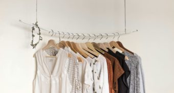 A variety of women's clothing hang on a retail rack, potentially sold by Aritzia.