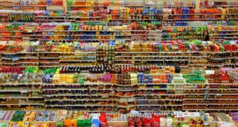 Many rows of shelves, potentially at a Dollar Tree location in Canada, are loaded with products.