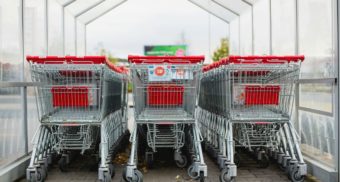 Many shopping cars gathered under a canopy, potentially at a Giant TIger location.