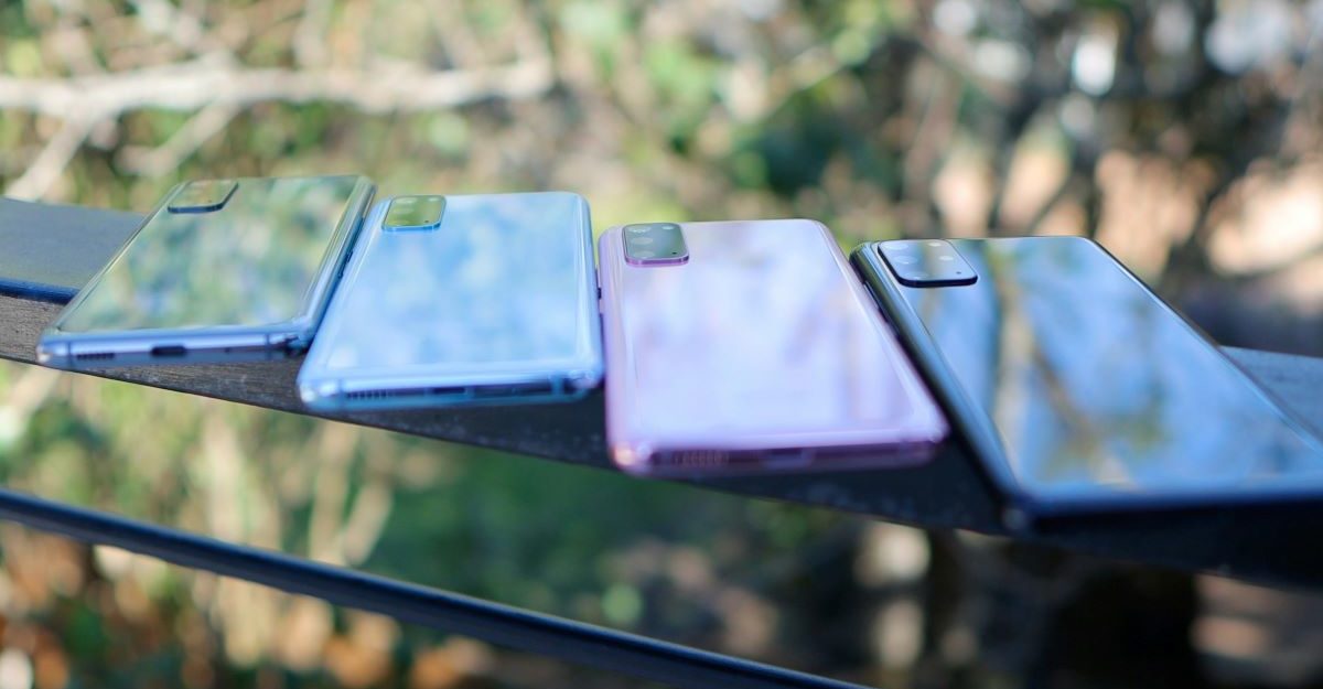 Four smartphones on display on a table, potentially located at a Glentel kiosk.