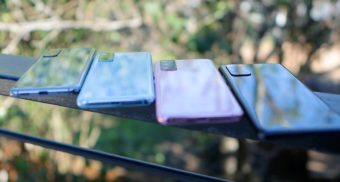 Four smartphones on display on a table, potentially located at a Glentel kiosk.