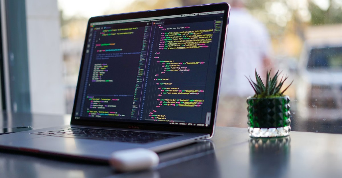 A photo of code on a laptop near a window. (Photo: James Harrison / Unsplash)