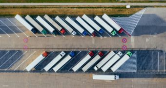 A fleet of parked trucks, likely overseen by a logistics manager.