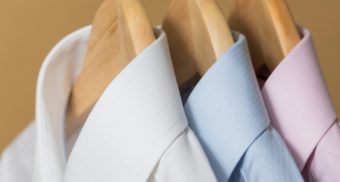 A close-up of three dress shirts on hangers, potentially sold by Shein Canada.