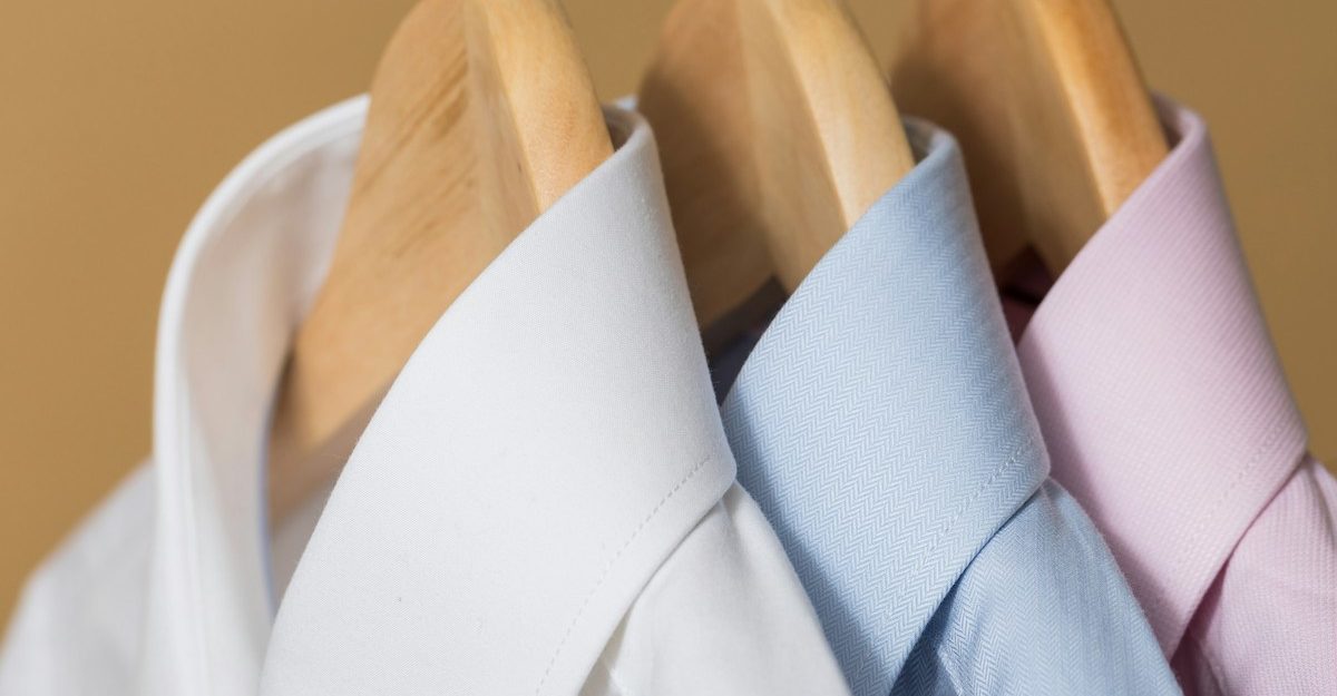 A close-up of three dress shirts on hangers, potentially sold by Simons.