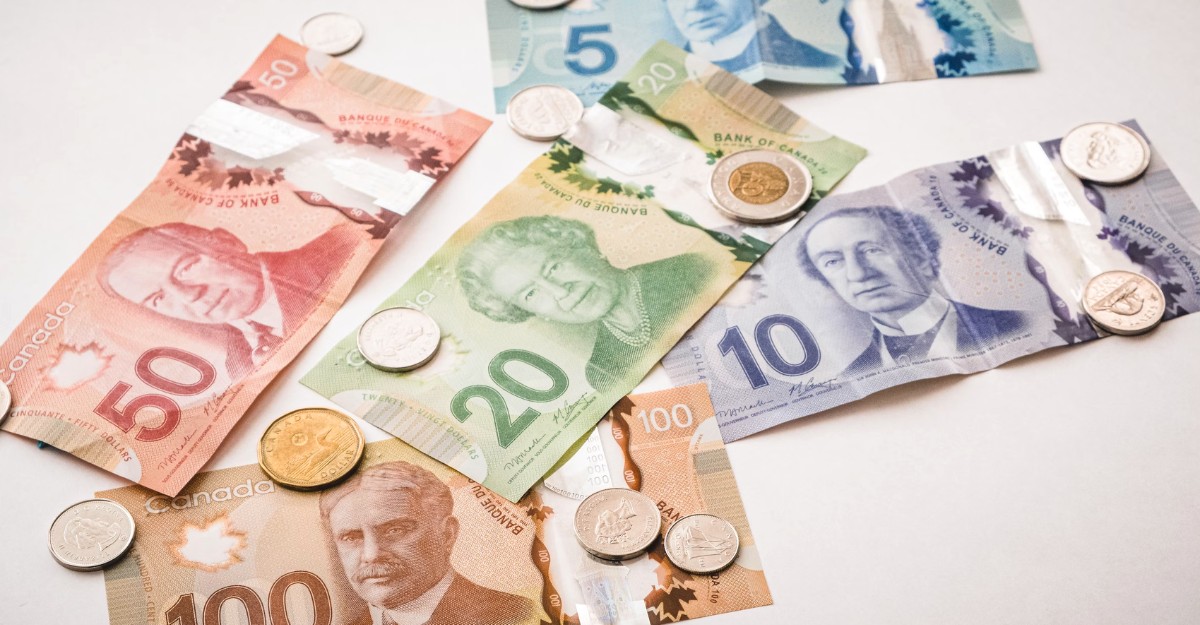 A photo of Canadian currency on a table. (Photo: PiggyBank / Unsplash)