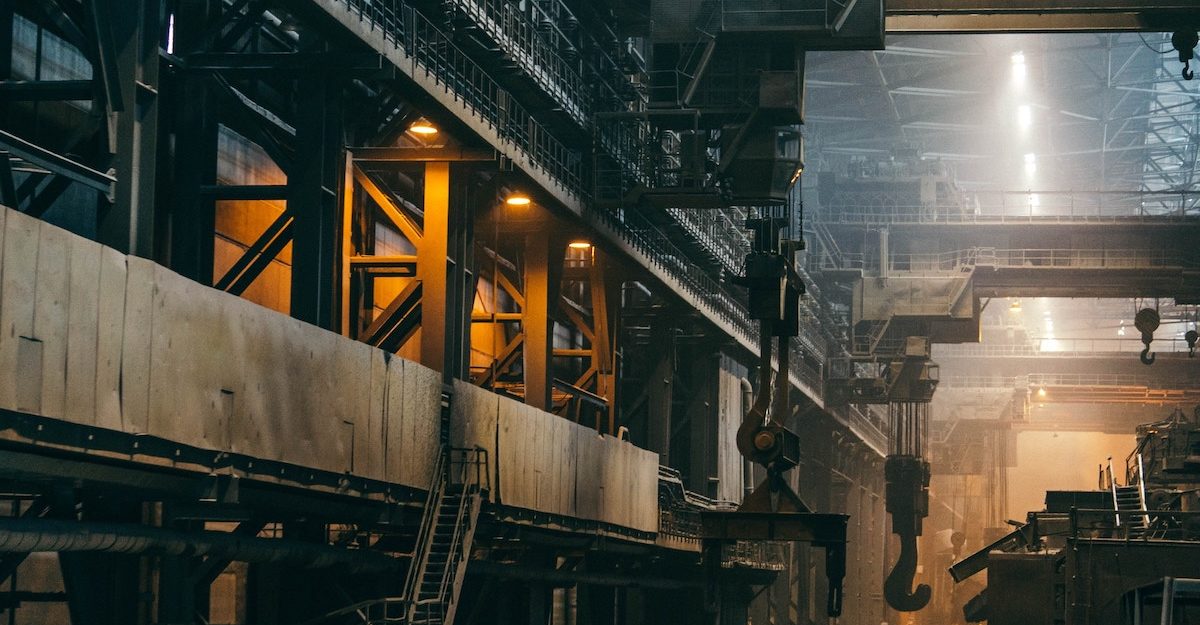 A labyrinth of walkways, ladders and equipment in a massive manufacturing plant. Cleveland-Cliffs employees are entitled to full severance pay when they lose their job.