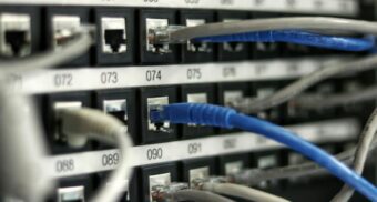 A number of cables are plugged into hardware likely used to run Equinix's data centres.