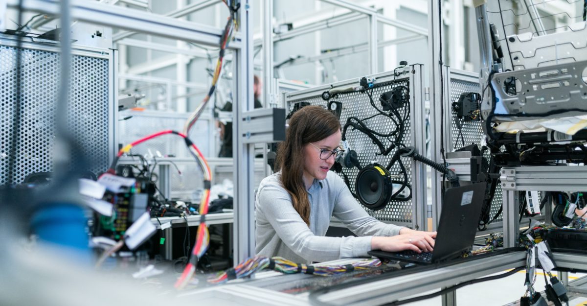 An engineer, potentially working for Qualcomm Canada, works with hardware and software.