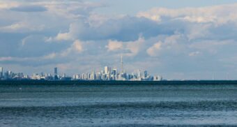 The Toronto skyline is seen in the distance next to Lake Ontario. Enwave uses the lake's water to naturally cool buildings.