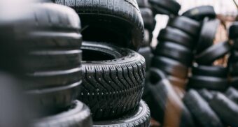 Numerous stacks of black tires. Goodyear employees are entitled to severance pay when they lose their job.