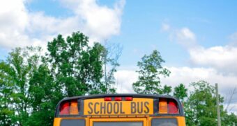 A school bus, potentially built by Lion Electric, beneath a partially cloudy sky.