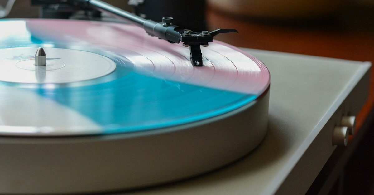 A vinyl record player, featuring music potentially licensed by Warner Music Group.