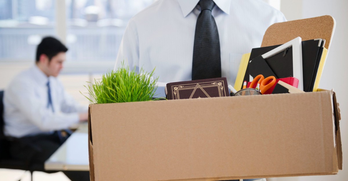 A worker leaving the office with his supplies. (Photo: The Balance Careers)