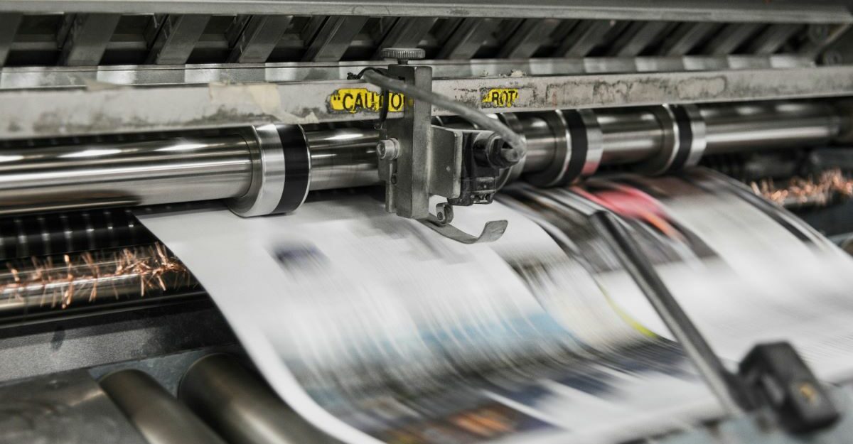 A machine prints products featuring colour ink.