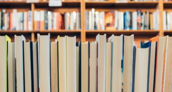 A photo of books stacked together. (Photo: Jessica Ruscello / Unsplash)