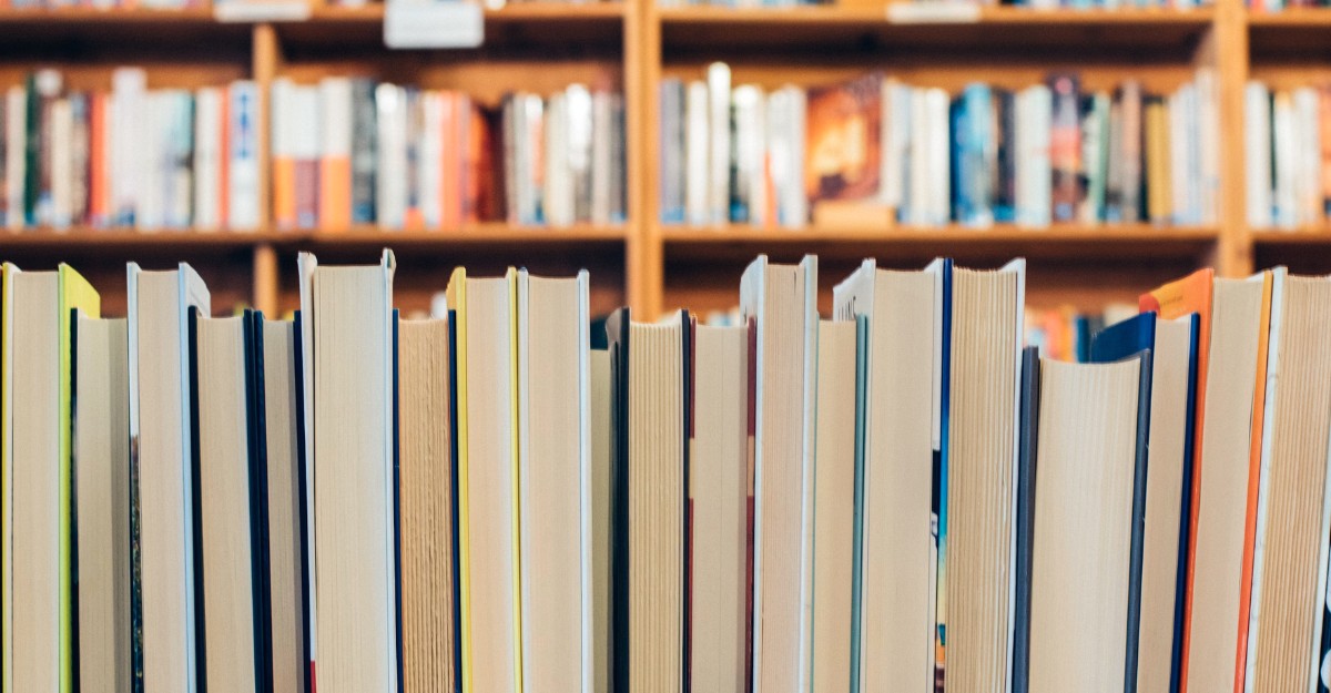 A photo of books stacked together. (Photo: Jessica Ruscello / Unsplash)