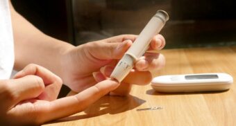 A person checking their blood sugar levels using a device. (Photo: isens usa / Unsplash)