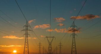 Energy transmission lines extending to the horizon, providing power overseen by IESO.