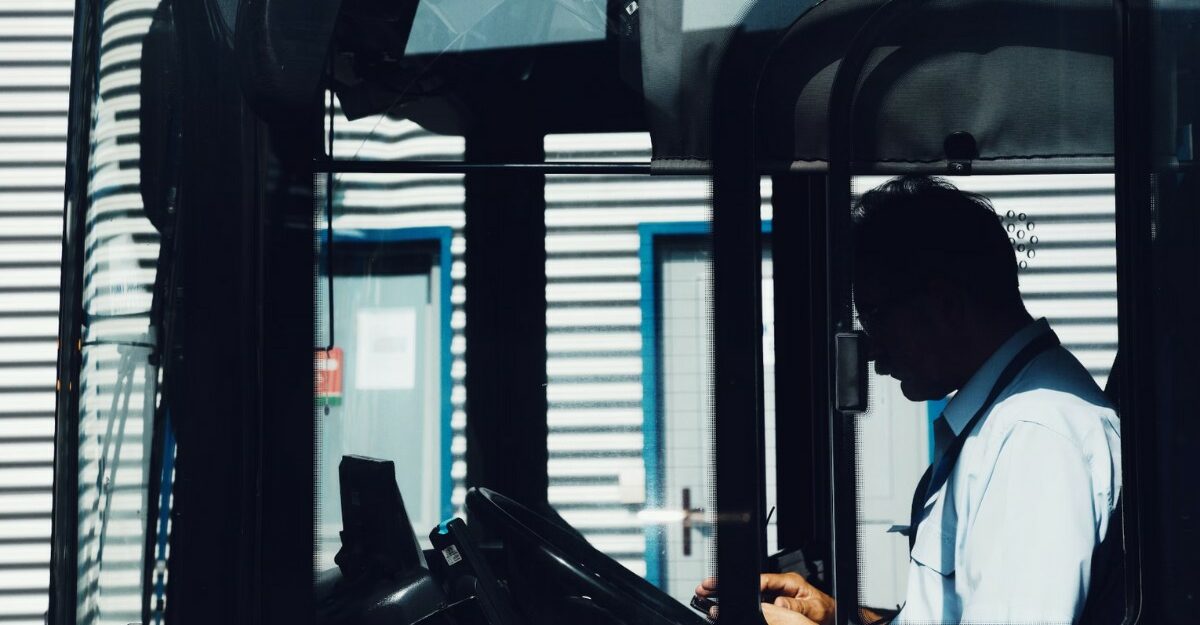 A silhouette of a person driving a bus. (Photo: Marjan Blan / Unsplash)