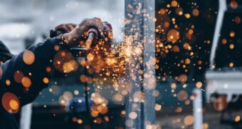 A photo of a person operating a piece of machinery. (Photo: Christopher Burns / Unsplash)