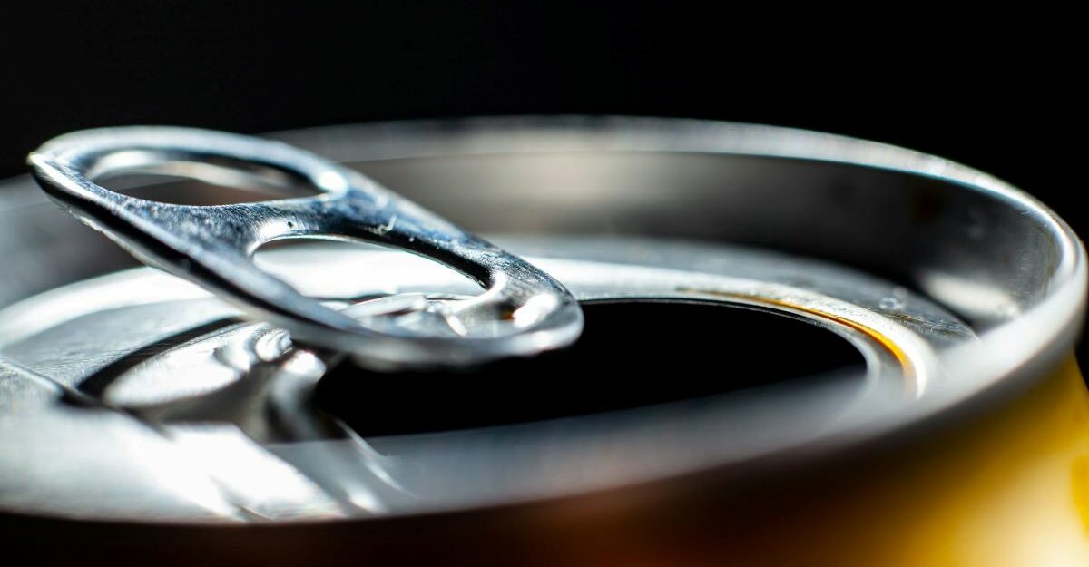 A close-up of the open top of an aluminum can.