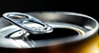 A close-up of the open top of an aluminum can.