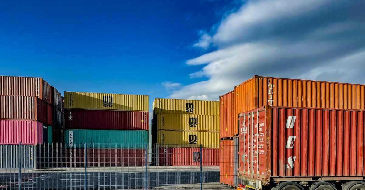 Stacked shipping containers await transportation.