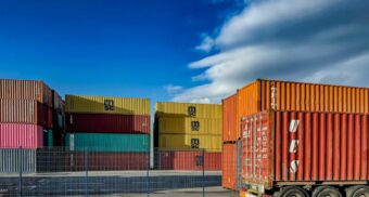 Stacked shipping containers await transportation.