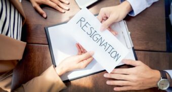 A person handing a resignation letter to their boss. (Photo: Audtakorn Sutarmjam, Getty Images)