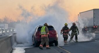 A photo of crews putting out a vehicle fire on Highway 401, south of Guelph, Ontario. (Photo: @OPP_HSD / X/Twitter)