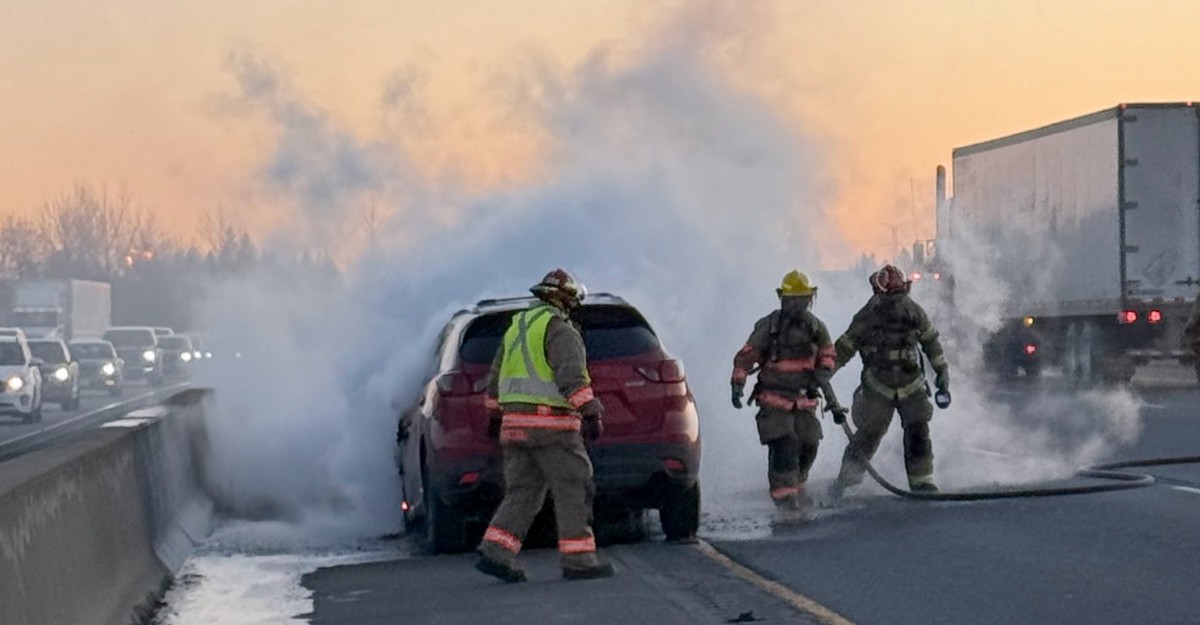 A photo of crews putting out a vehicle fire on Highway 401, south of Guelph, Ontario. (Photo: @OPP_HSD / X/Twitter)