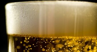 A close-up photo of beer in a glass. (Photo: yesmorecontent / Unsplash)