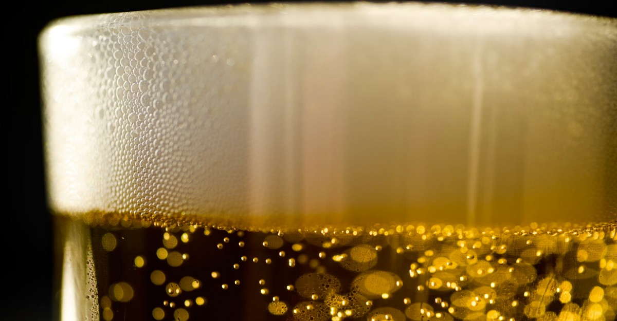 A close-up photo of beer in a glass. (Photo: yesmorecontent / Unsplash)