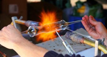 A skilled glassmaking professional at work.