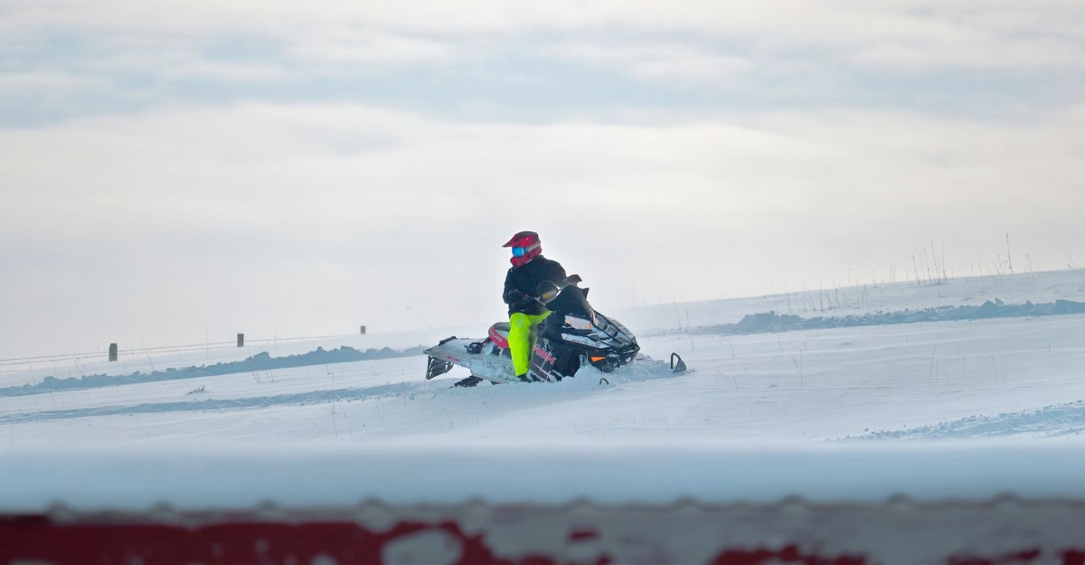 A photo of a person on a snowmobile. (Photo: livekaiah / Unsplash)