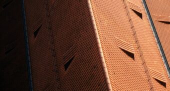 An aerial shot of a well-maintained Spanish tile roof.