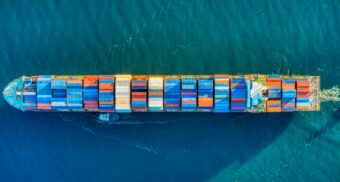 An aerial view of a cargo ship transporting a variety of containers. (Photo: Venti Views / Unsplash)