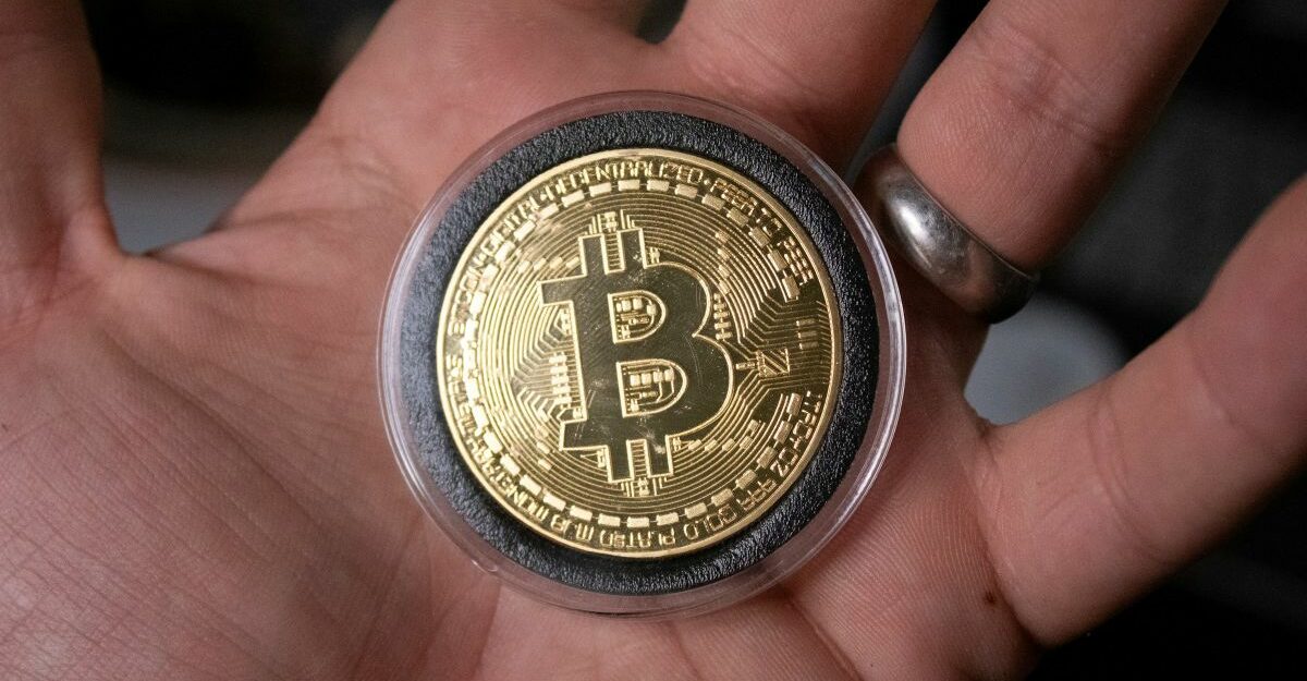 bitcoin-palm-hand A Bitcoin sits in the palm of someone's hand.