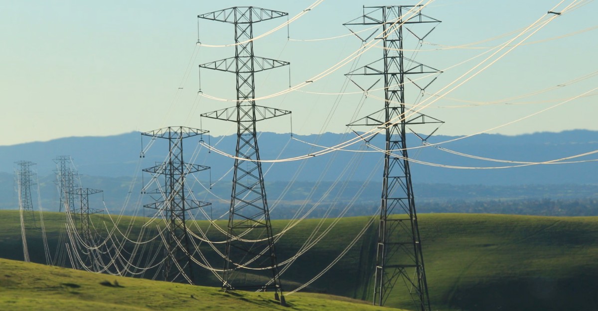 bruce-power-layoffs A photo of power lines across a green field. (Photo: Annabella Parrales / Unsplash)